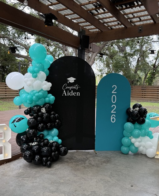 Blue and black graduation balloon installation